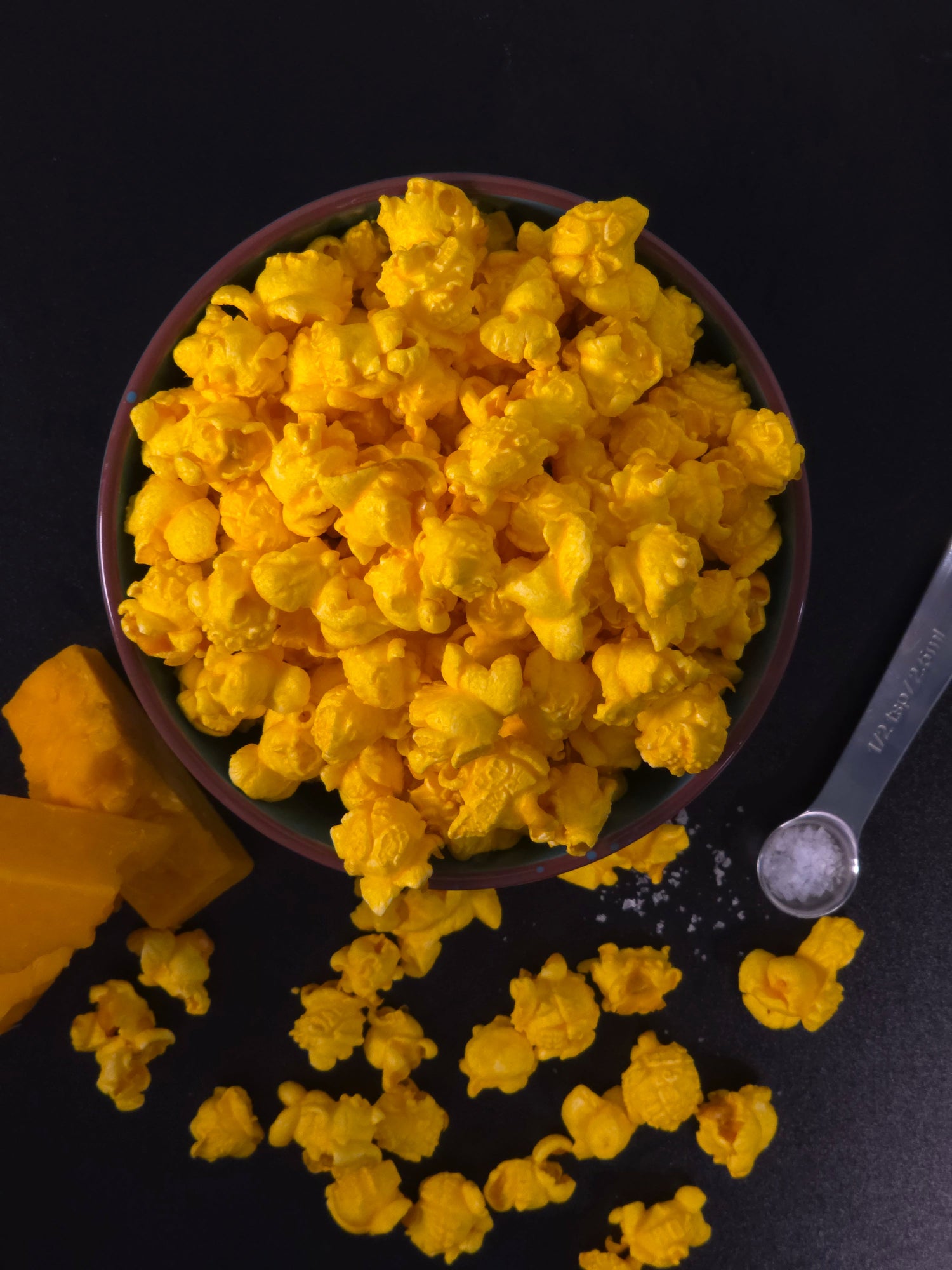 Gourmet mixed popcorn with caramel and cheese in a white ceramic bowl