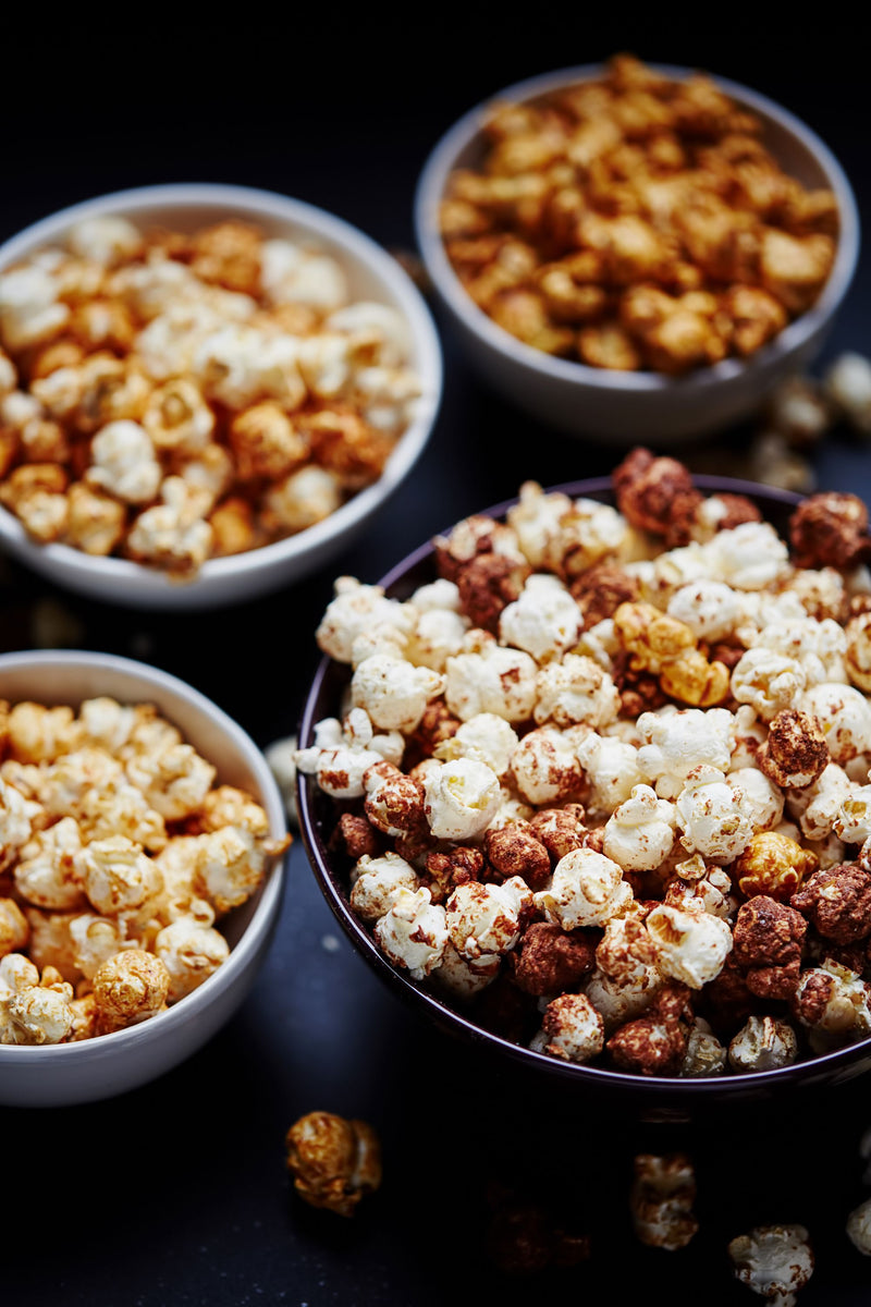 Assorted gourmet popcorn flavors in bowls